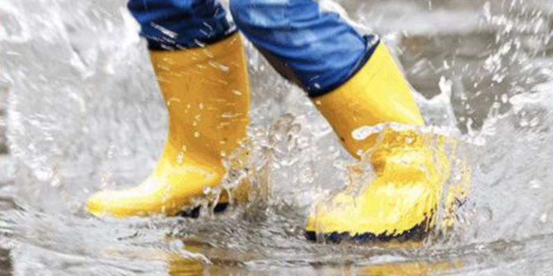 rain boots jumping in puddle